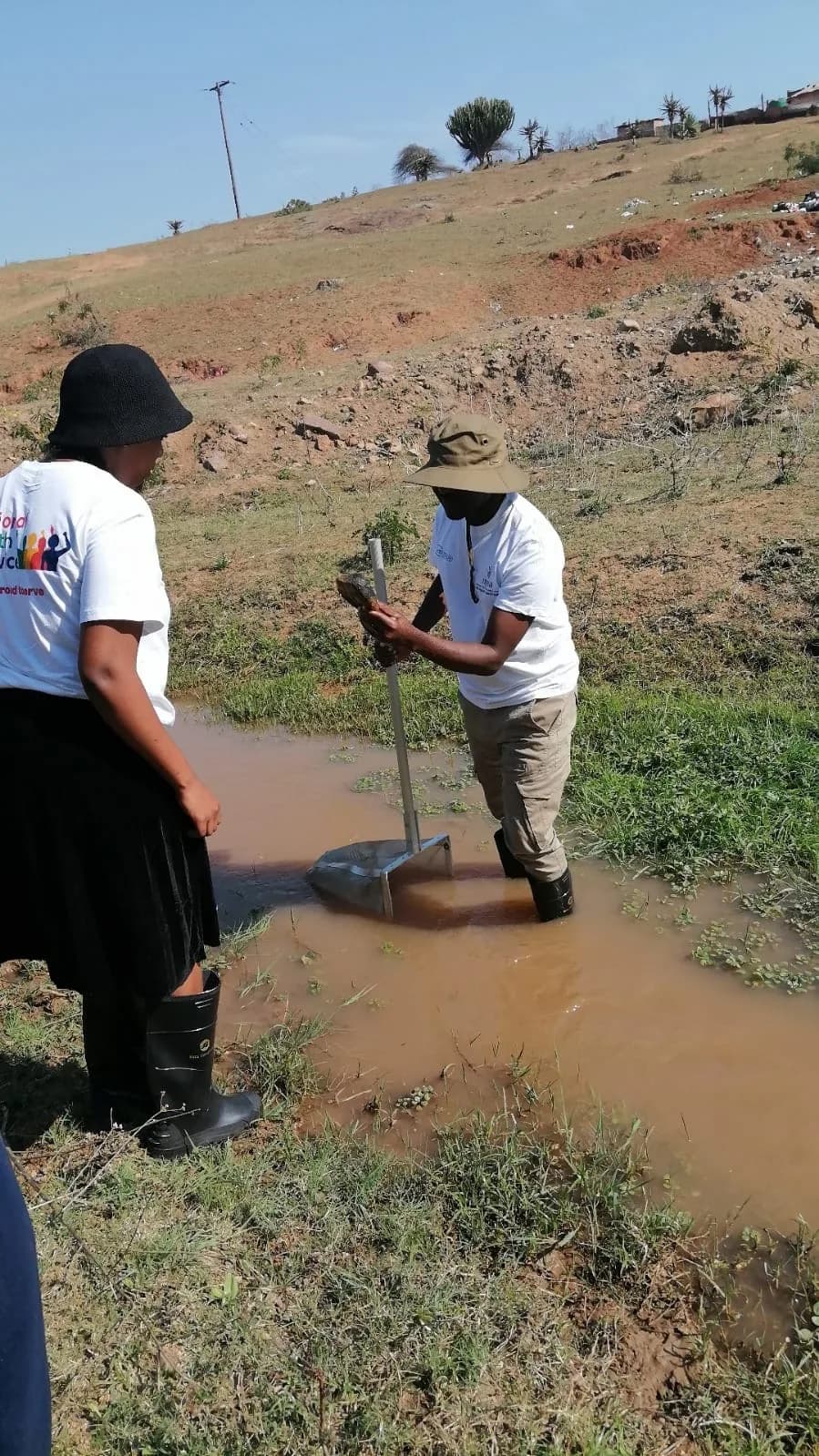 Participants sampling river health with miniSASS